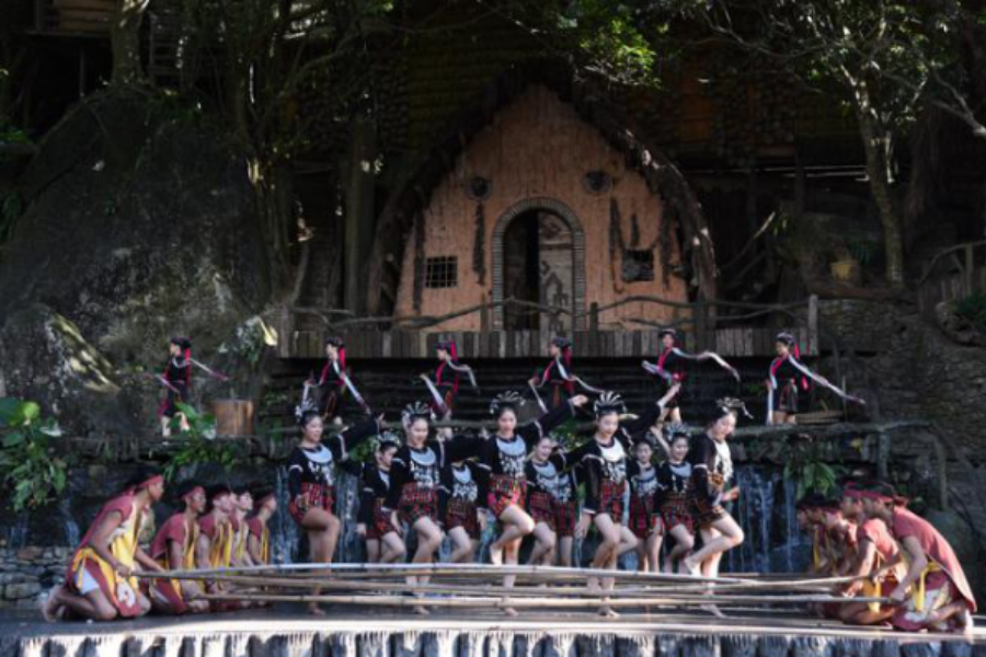 Young folks have a ball during a traditional Hainan bamboo pole dance in a musical drama called the Charm of Li and Miao Culture. It takes place at the Binglanggu Li and Miao Cultural Heritage Park and showcases their bountiful hospitality. [Photo/chinadaily.com.cn]